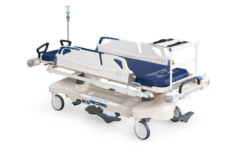 Camilla de Emergencia Paramount Bed con 2 IV poles abatibles y mesa monitor